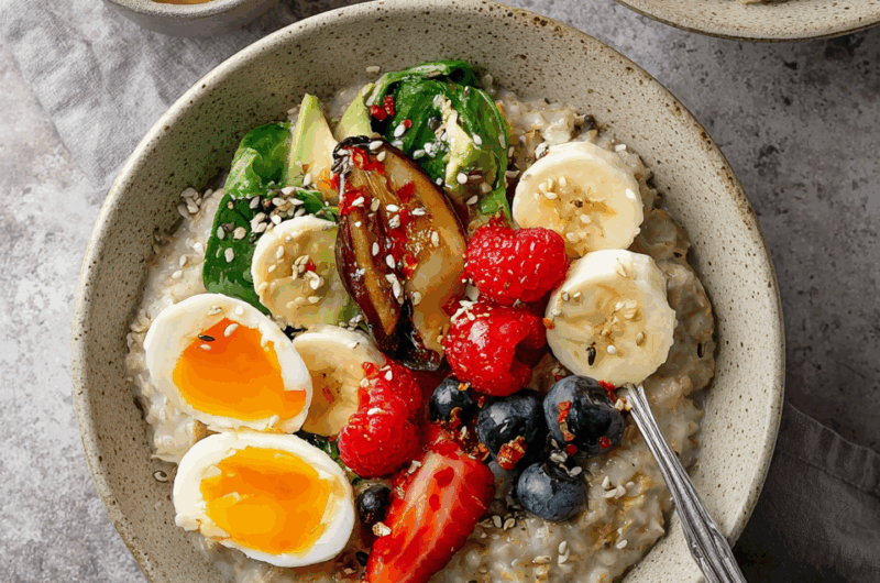 Hearty Savory Oatmeal Topped with Fresh Poached Egg and Spinach